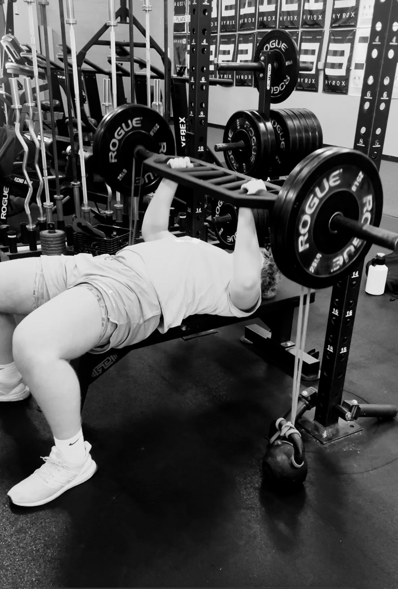 Ethan, 17, bench pressing with football bar training with Mark McIntosh in Knoxville
