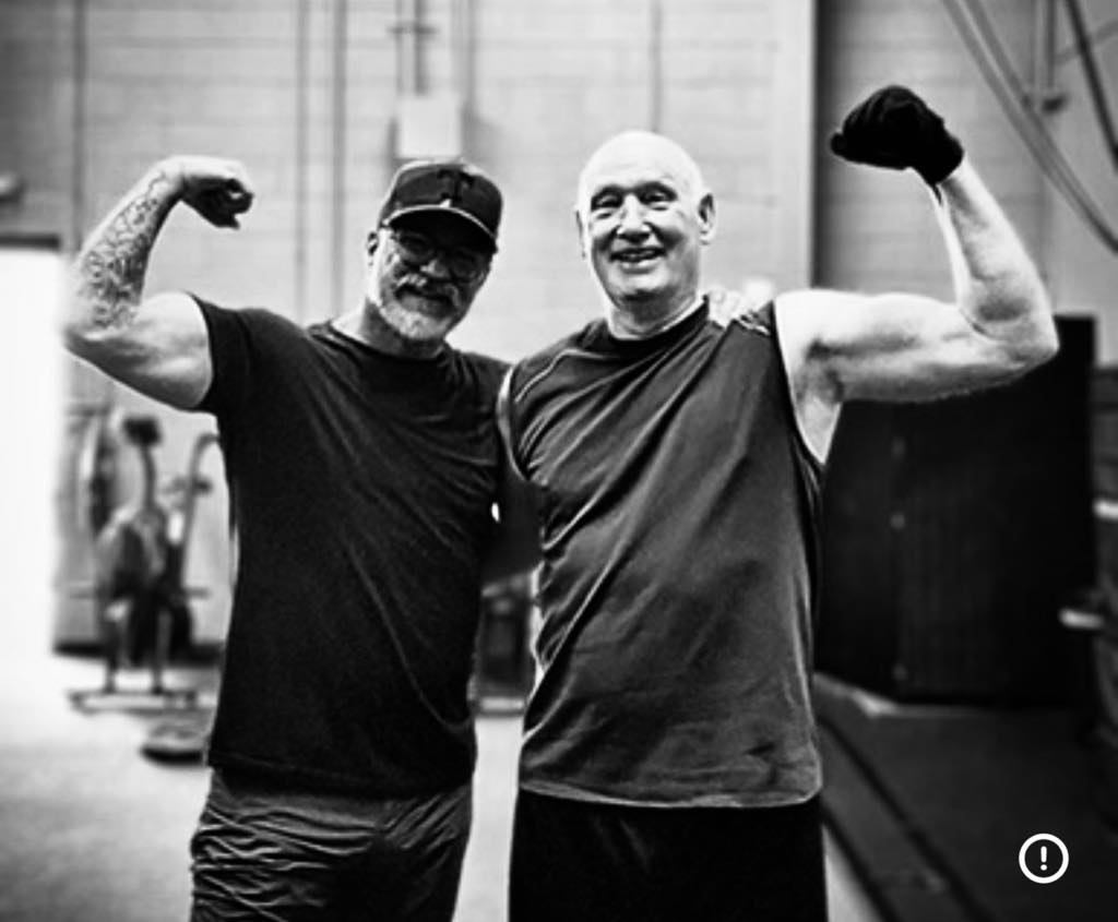 Mark McIntosh with client Bob both flexing after training session